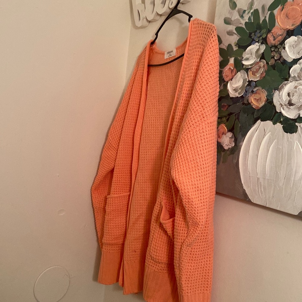 This coral Cardigan is beautiful. I bought it from a boutique. It’s new.